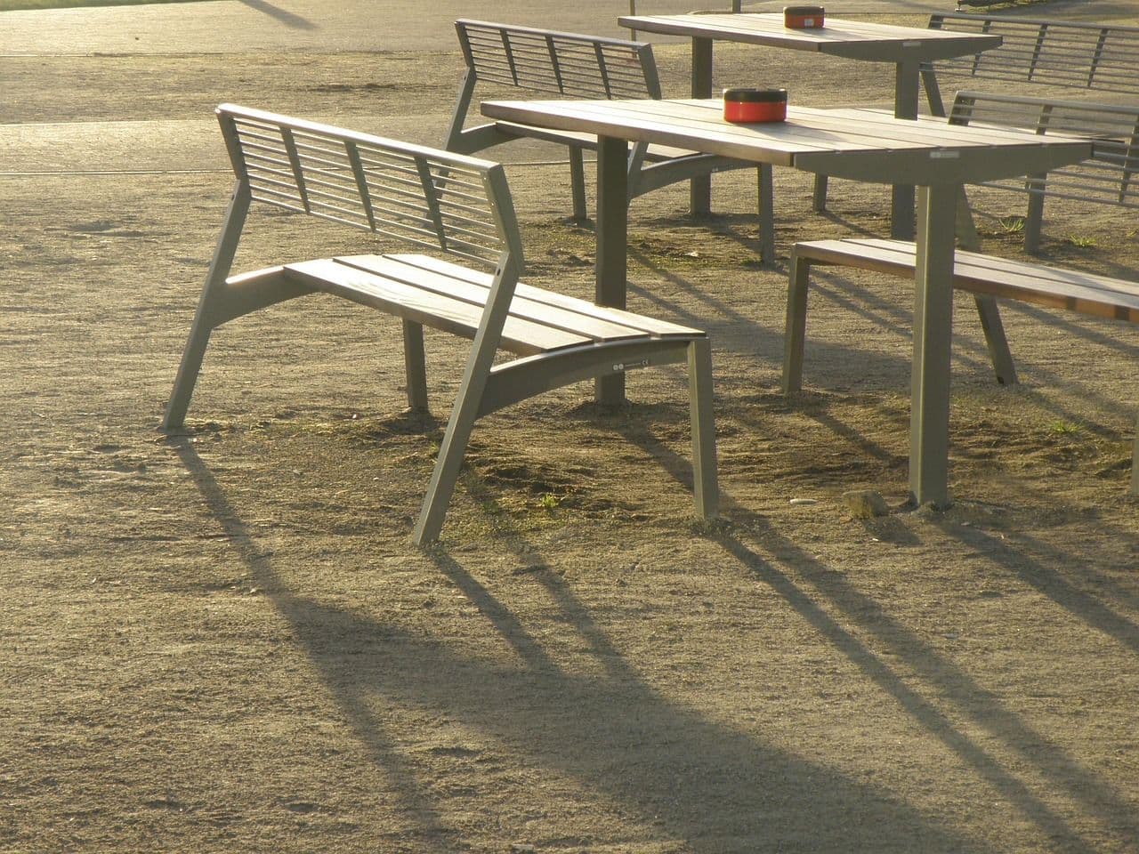 a grey/white plastic bench and picnic table