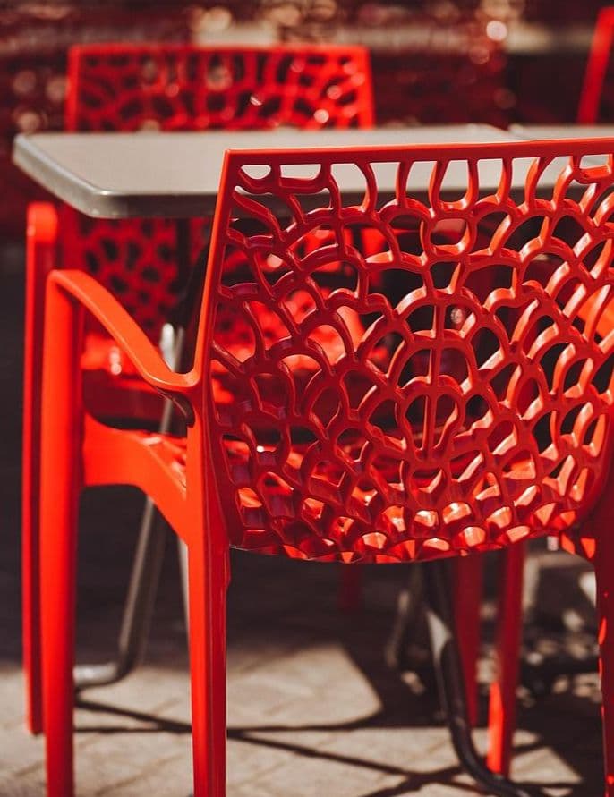 red plastic chair as part of an outdoor furniture collection